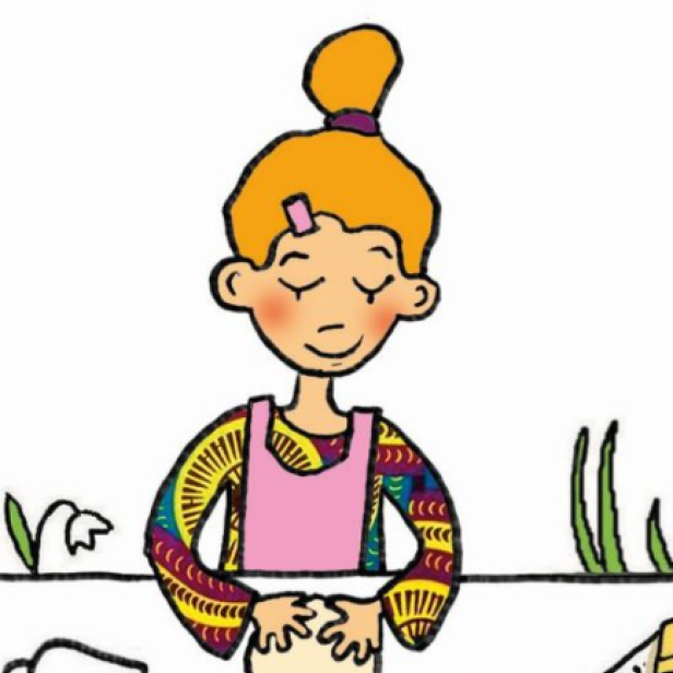 Eine junge Frau mit rotem Haar knetet Teig in einer Küche.