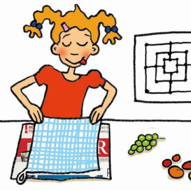 Ein Mädchen bastelt mit Papier und Schere an einem Tisch mit Spielsteinen.
