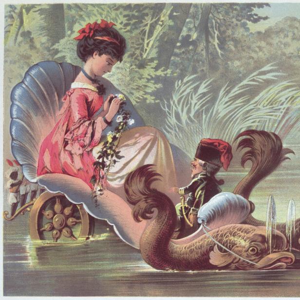 Eine Frau sitzt in einer Muschelkutsche, gezogen von einem Mann auf Fischfiguren, inspiriert von „Nussknacker und Mausekönig“.