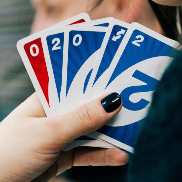 Eine Hand hält Karten des Spiels Uno.