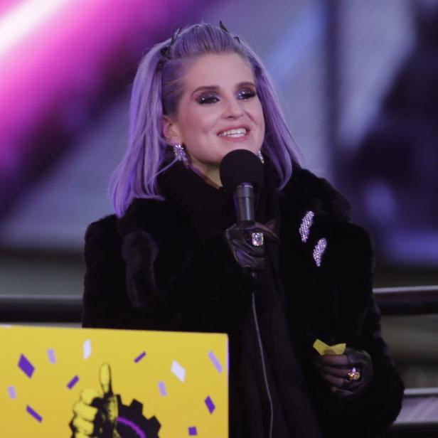 Kelly Osbourne spricht bei einer Veranstaltung in ein Mikrofon.
