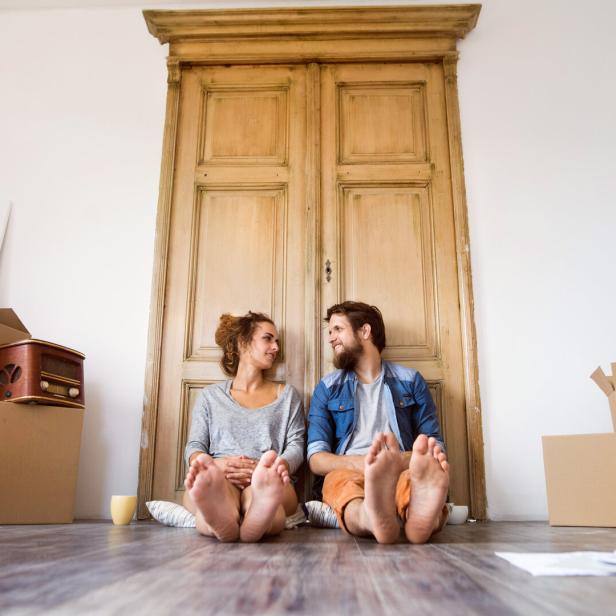 Young couple moving in new house, resting.
