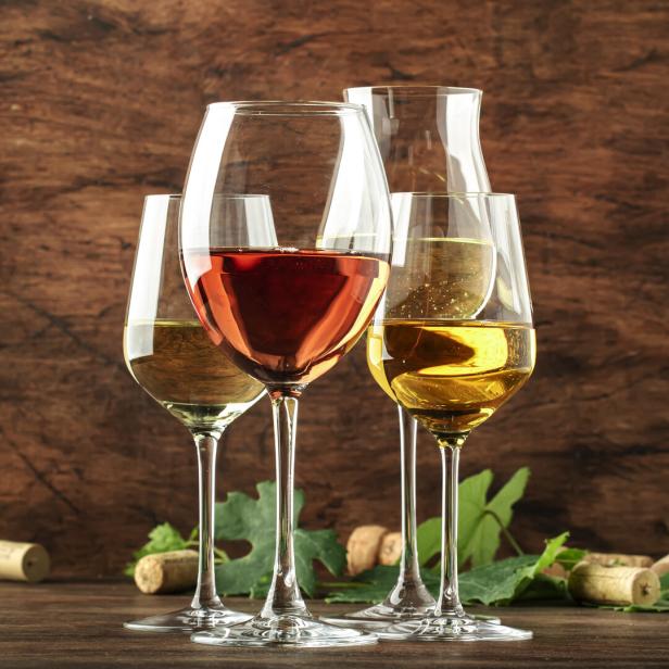 White wine set. Wine tasting, the most popular varieties of white wines in wine glasses on vintage wooden table in rustic style, selective focus