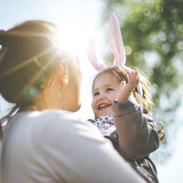 Mutter hält Kind in der Sonne 