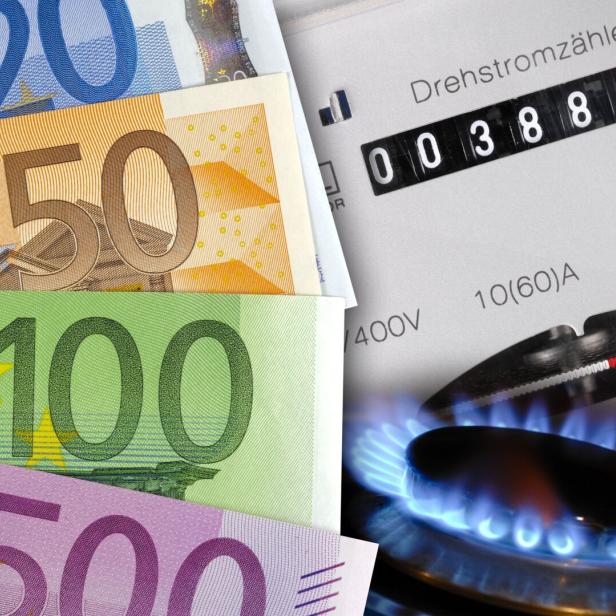 Mehrere Euro-Geldscheine liegen neben einem Gasherd mit Flamme und einem Stromzähler.