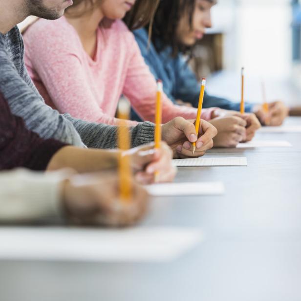 Cropped view of group of teenagers taking a test