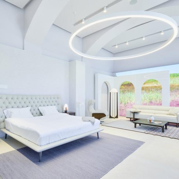 Ein Schlafzimmer mit Doppelbett und Wohnbereich in einem hellen, modernen Design.