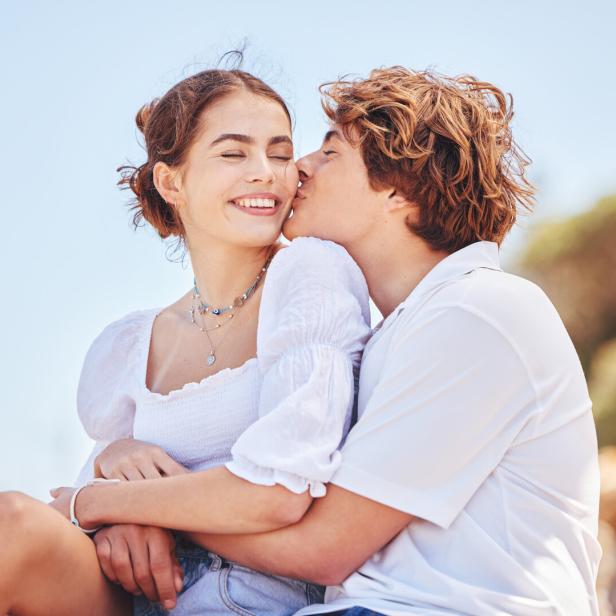Shot of a young couple spending time together at the beach