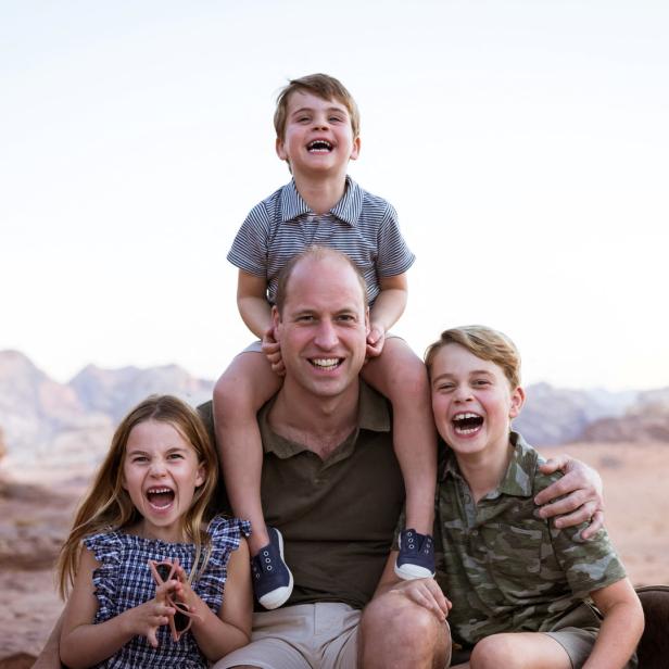 Prinz William mit seinen drei Kindern, Prinz George, Prinzessin Charlotte und Prinz Louis, in einer Wüstenlandschaft.