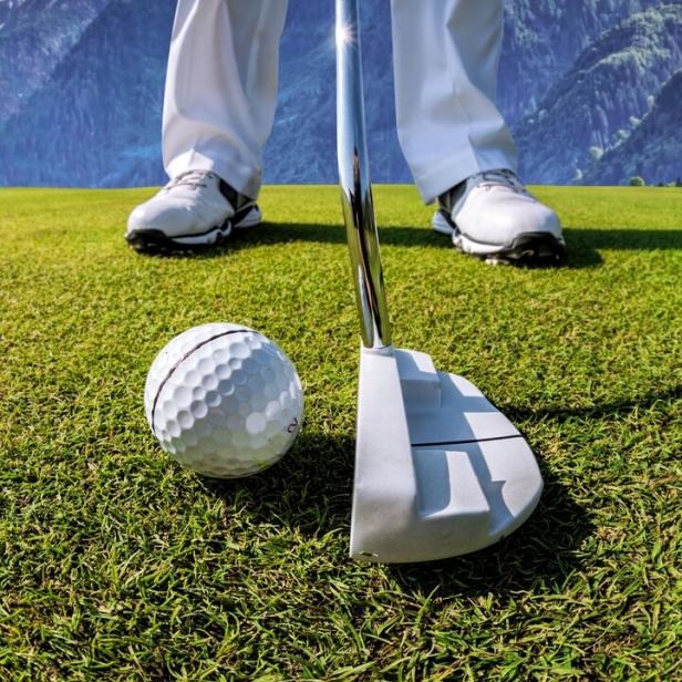 Man playing golf in Kaprun golf center against Kitzsteinhorn, Austria