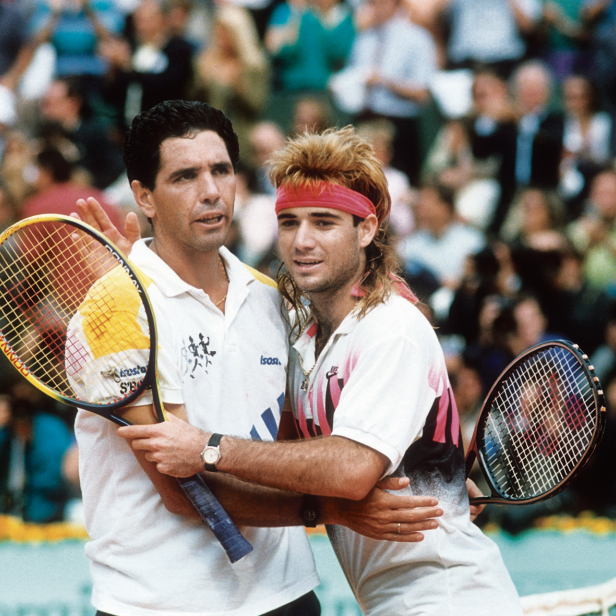Andrés Gómez umarmt Andre Agassi nach einem Tennismatch.