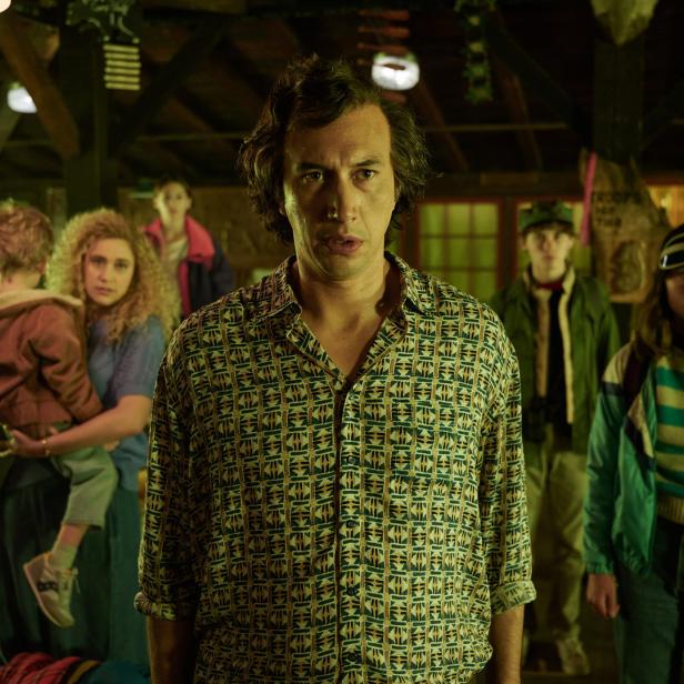 Adam Driver steht mit anderen Darstellern in einer Szene aus dem Film „White Noise“.