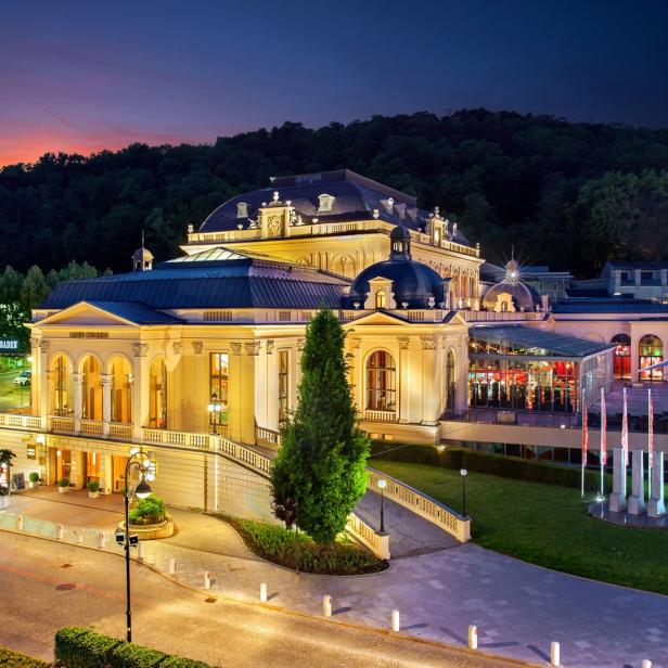 Das Casino Baden-Baden in der Abenddämmerung mit beleuchteter Fassade.