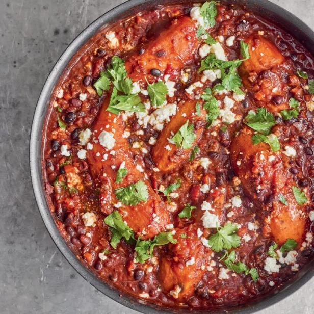 Ein Topf mit Süßkartoffel-Chili, garniert mit Koriander und Feta-Käse.