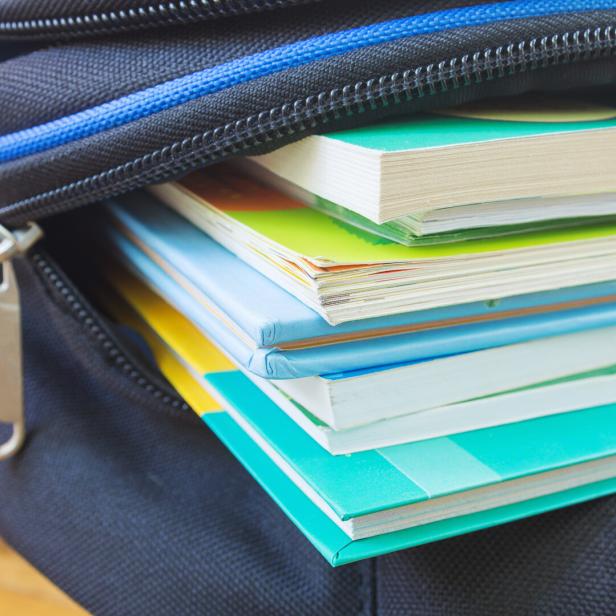 Textbooks in the school backpack, education concept.  Selective focus.