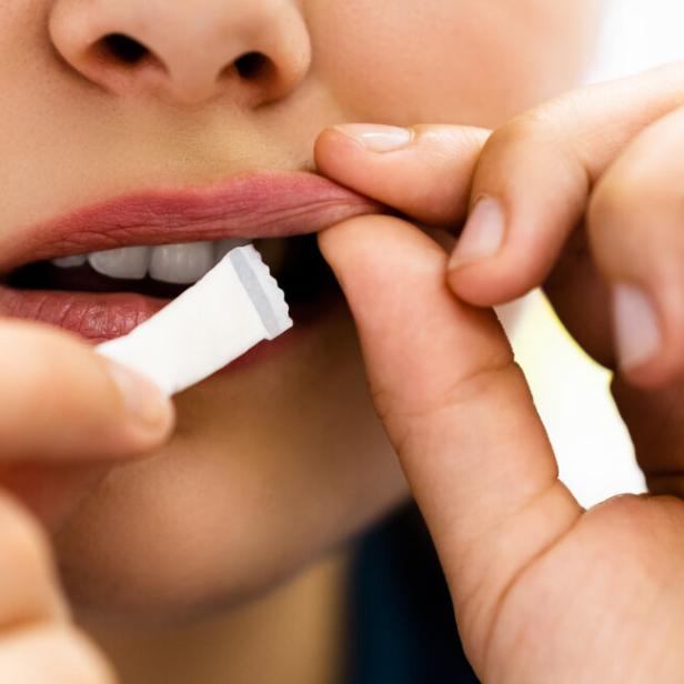 Woman Chewing Wet Moist Nicotine Product