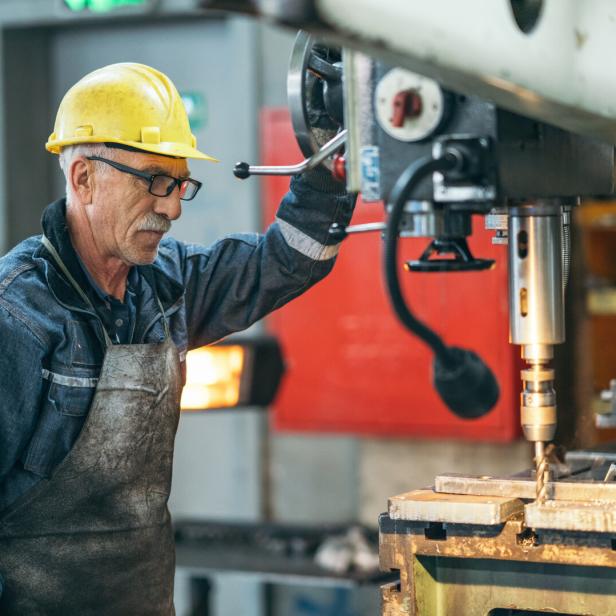 Turner worker working on drill bit in a workshop