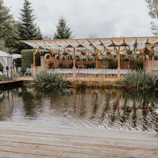 Ein Veranstaltungsort am Wasser mit einem Pavillon und Stuhlreihen für eine Zeremonie.