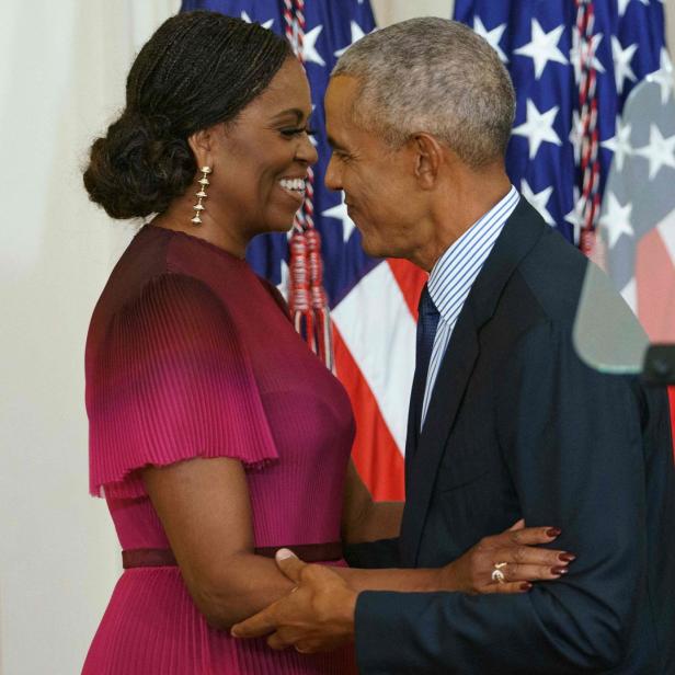 Michelle und Barack Obama stehen einander zugewandt.