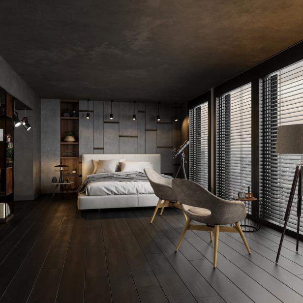 Ein Schlafzimmer mit dunklem Holzboden, großem Fenster und zwei Sesseln.