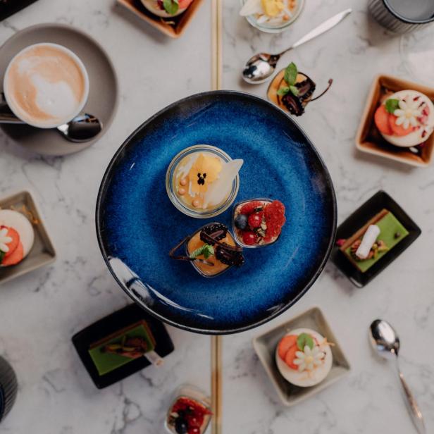 Ein Arrangement aus verschiedenen Desserts und Getränken auf einem Tisch.