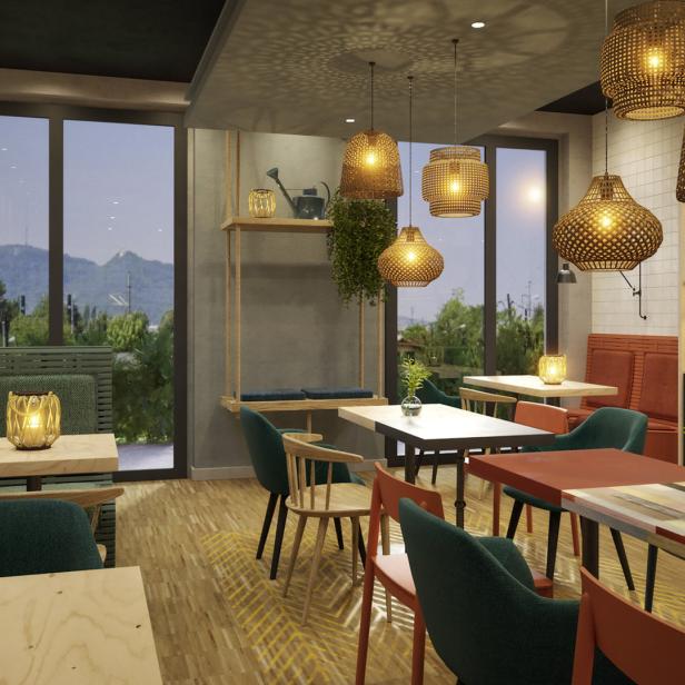 Ein helles Restaurant mit verschiedenen Sitzbereichen und dekorativen Lampen.