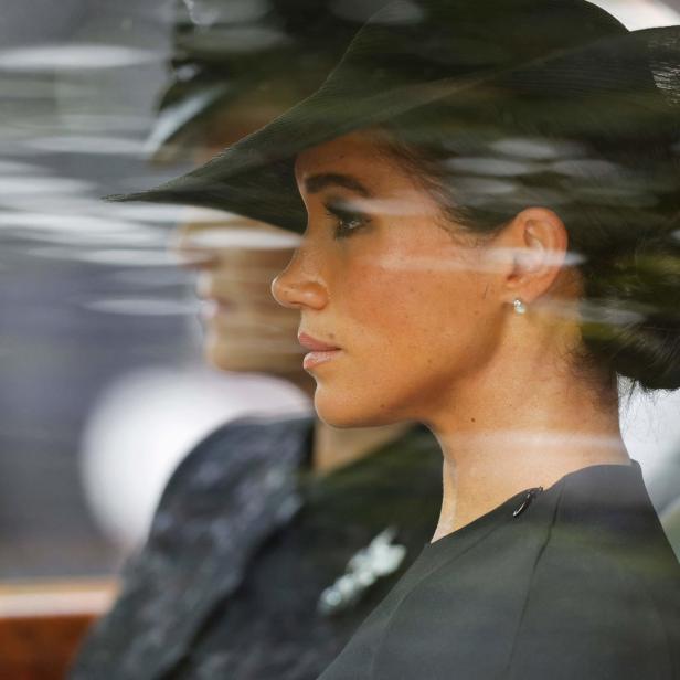 Meghan, Herzogin von Sussex, mit Hut in einem Auto.
