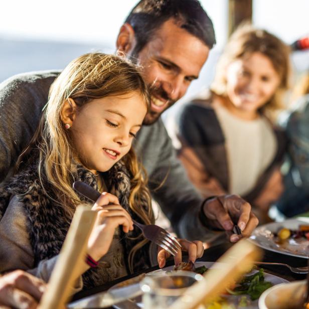 Eine Familie genießt gemeinsam ein festliches Essen am Tisch.