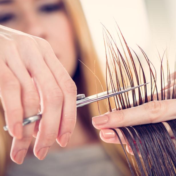 Eine Friseurin schneidet einer Kundin die Haare.