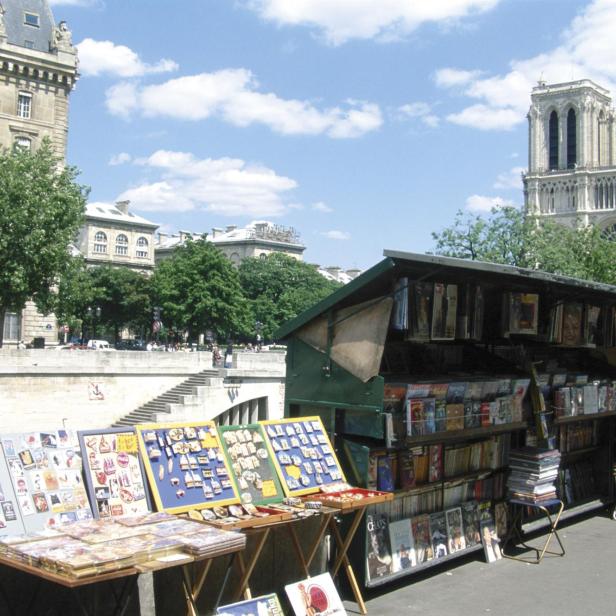 Ein Bücherstand an der Seine in Paris mit Blick auf Notre-Dame.