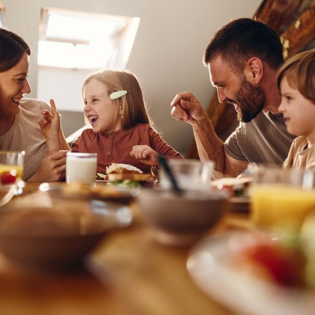 Familie isst gemeinsam am Tisch.