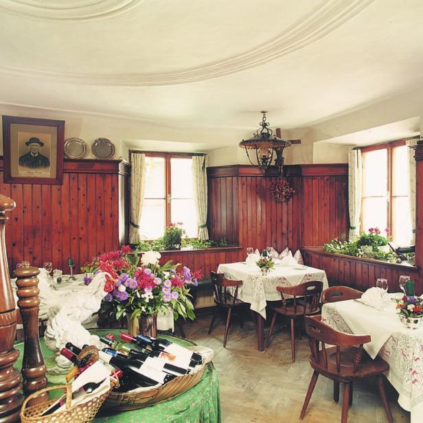Ein traditionelles Restaurant mit Holztäfelung und gedeckten Tischen.