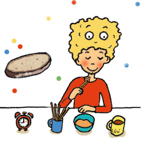 Ein Junge isst Brotstangen mit Dip am Tisch.