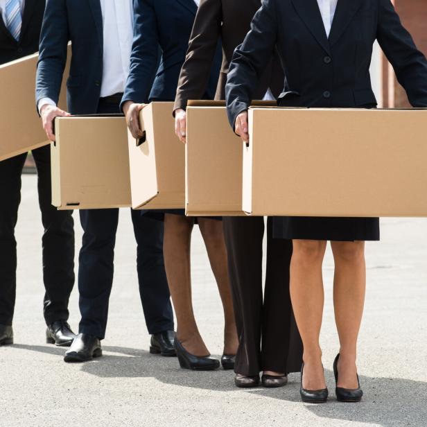 Businesspeople With Cardboard Boxes Standing In A Line