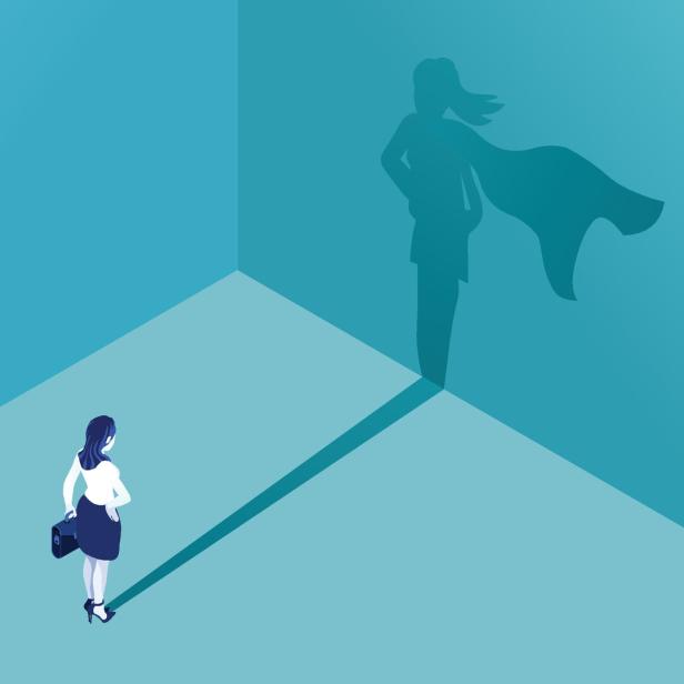 Eine Frau wirft einen Schatten, der sie als Superheldin mit Umhang zeigt.