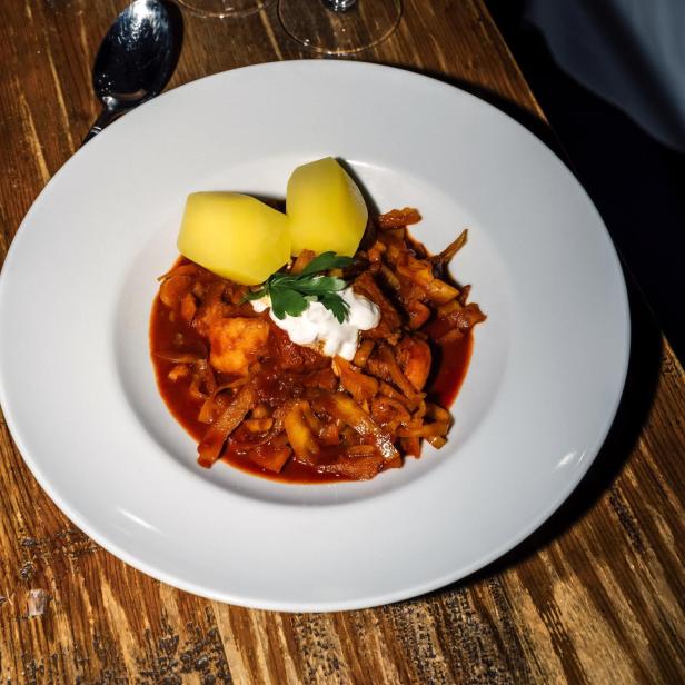 Szegediner Krautfleisch auf einem Teller mit zwei Kartoffeln.