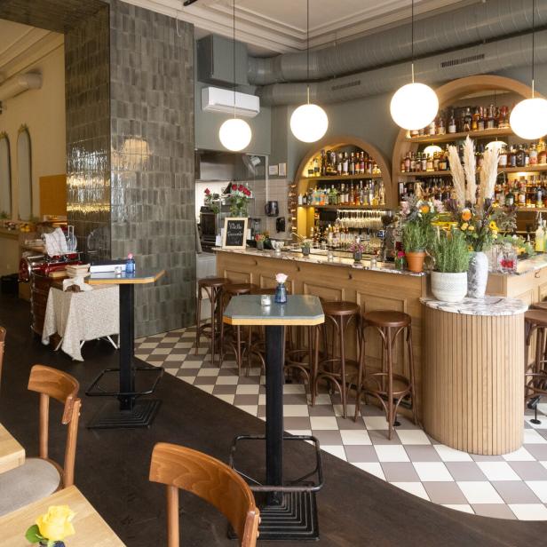 Innenansicht der Alexandra Bar-Aparitivo mit Tischen, Stühlen und einer Bar.