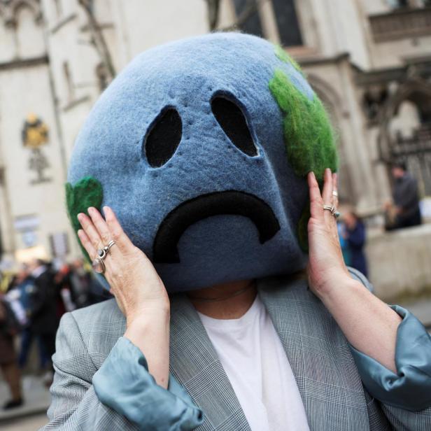 Climate activist demonstrates outside the high court in London