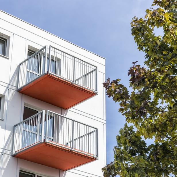 Red balconies in white apartment building