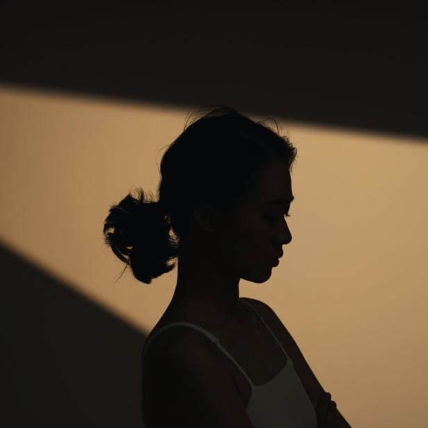 Schatten-Foto einer jungen, nachdenklichen Frau.