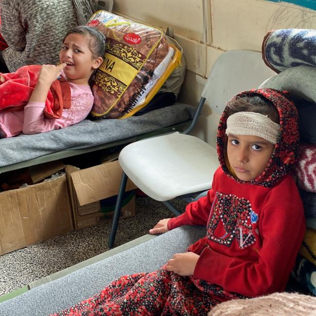 Palestinians wounded in Israeli strikes shelter in a school where they experience food shortages, near Rafah