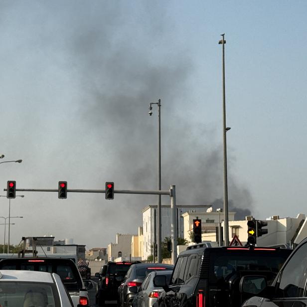 Smoke rises after several blasts were heard in Doha