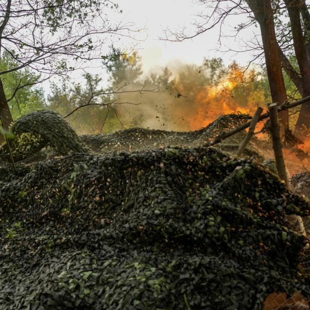 Service members of the 24th Separate Mechanized Brigade of the Ukrainian Armed Forces fire a 2S3 Akatsiya towards Russian troops on the front line, in Donetsk region