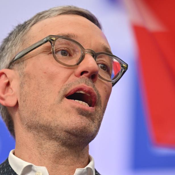 Herbert Kickl singend vor Hintergrund in Parteifarben