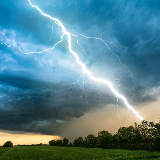 cloud storm sky with thunderbolt over rural landscape