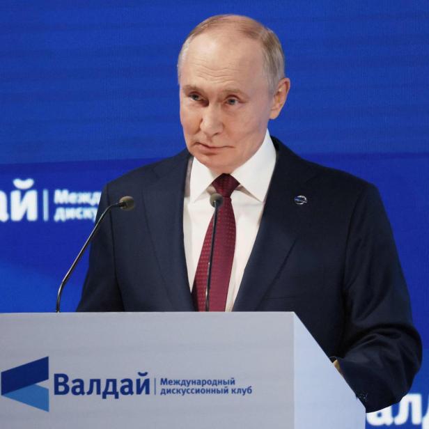 Wladimir Putin spricht vor dem Hintergrund des "Waldai"-Logos an einem Rednerpult.