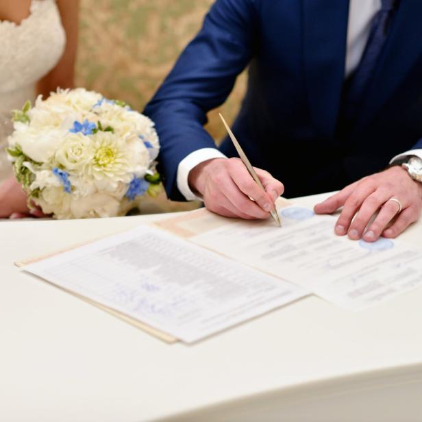 Beauty bride and handsome groom are registering the marriage
