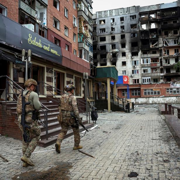 FILE PHOTO: Ukrainian police officers try to persuade residents to evacuate in the frontline town of Pokrovsk