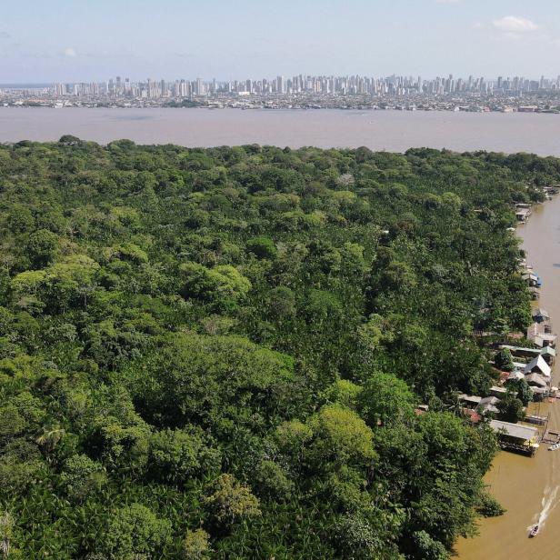 FILE PHOTO: A drone image shows the Amazon rainforest and the city of Belém in the back ahead of COP 30, at Ilha do Combu, in Belem