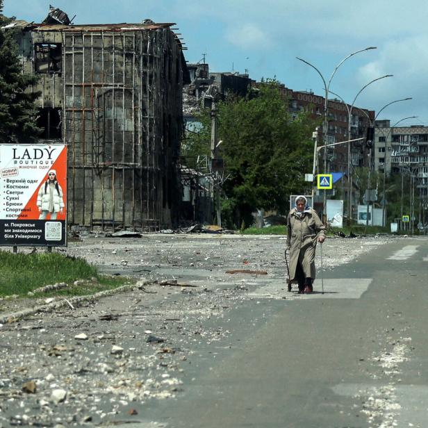FILE PHOTO: A resident walks at a street near buildings in the frontline town of Pokrovsk